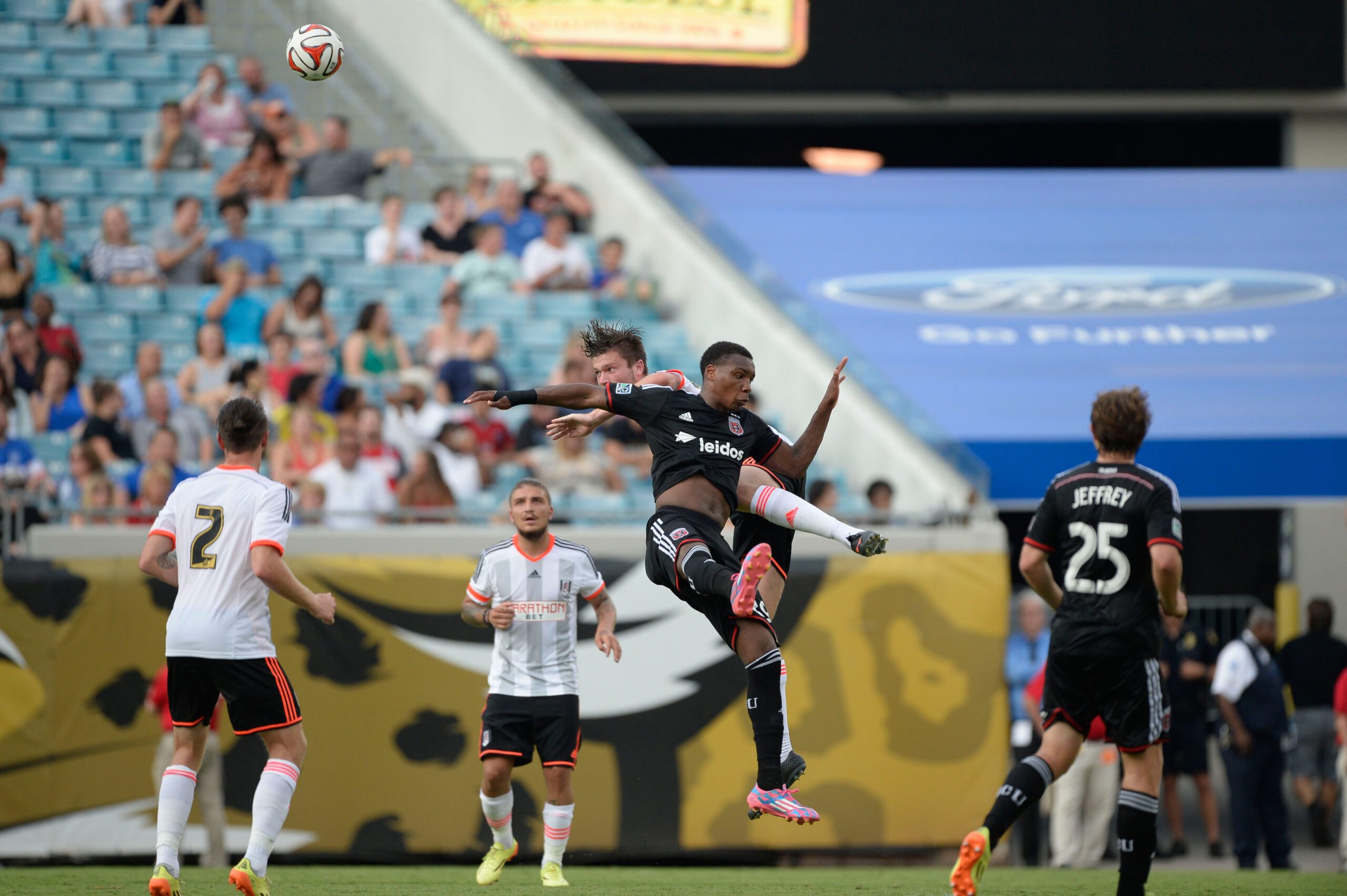 Jul 26, 2014; Jacksonville, FL, USA;  D.C. United forward Michael Seaton (29) heads the ball against Fulham FC at EverBank Field. Mandatory Credit: Richard Dole-Imagn Images
