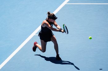 Jan 14, 2024; Melbourne, Victoria, Australia; Sarah Bejlek of the Czech Republic hits a shot against Leylah Fernandez of Canada in the first round of the women s singles. Mandatory Credit: Mike Frey-Imagn Images