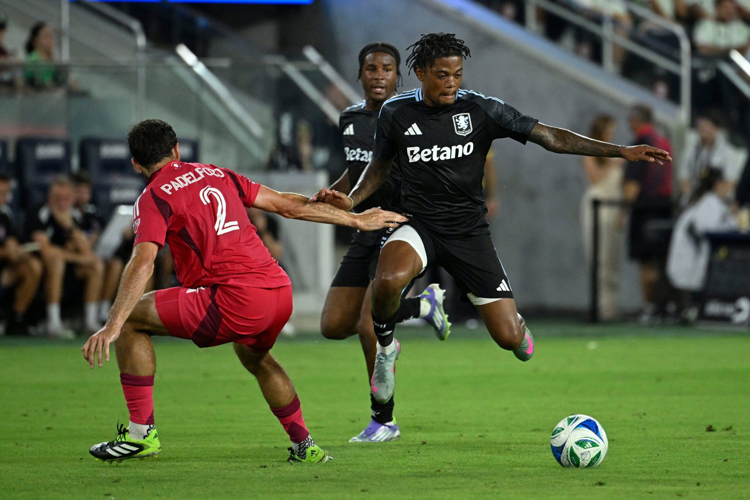 Jul 30, 2025; St. Louis, Missouri, USA; St. Louis City defender Devin Padelford (2) defends against Aston Villa midfielder Leon Bailey (31) in the first half at Energizer Park. Mandatory Credit: Joe Puetz-Imagn Images
