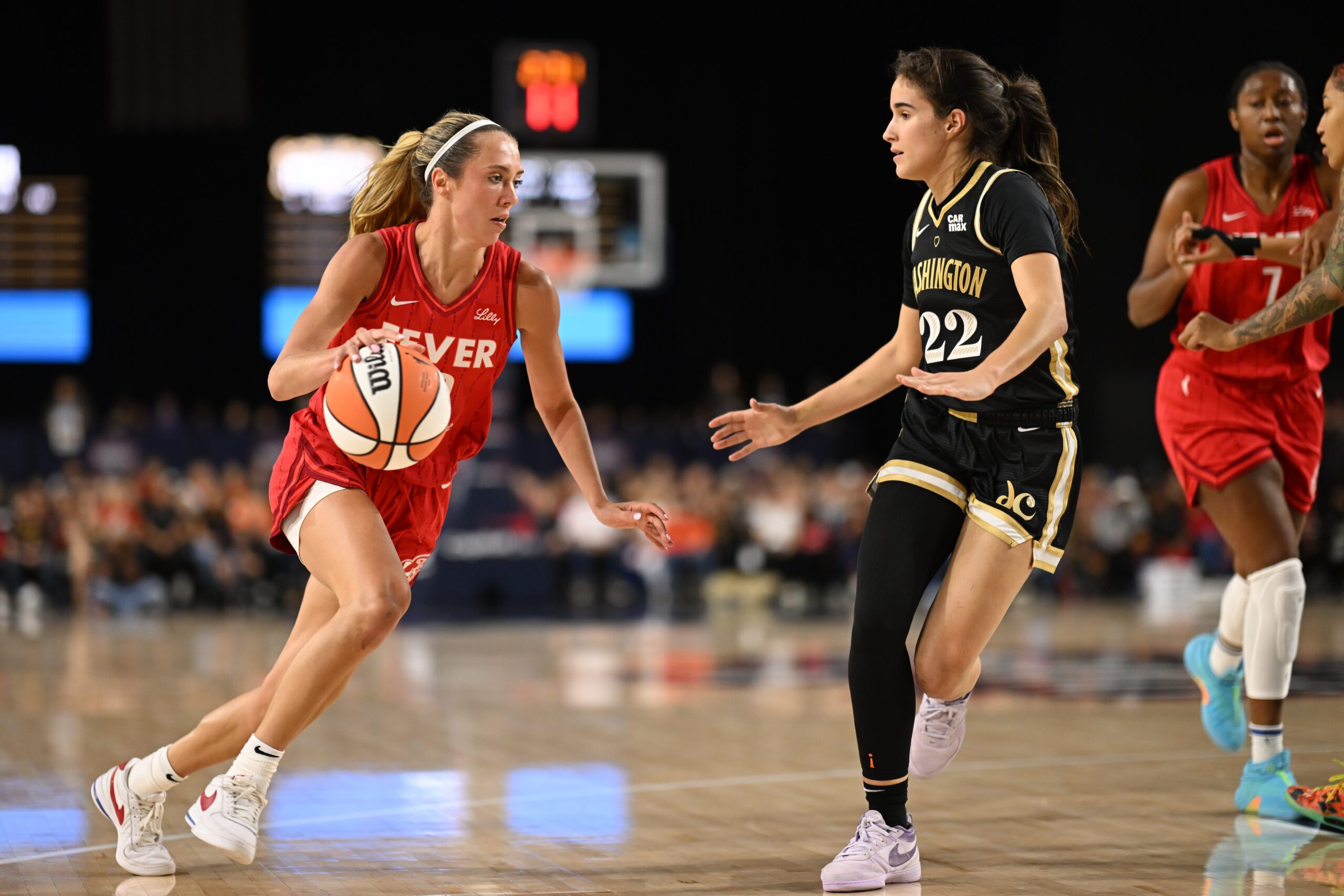 Sep 7, 2025; Baltimore, MD, USA; Indiana Fever guard Lexie Hull (10) attempts to drive past Washington Mystics guard Sonia Citron (22) during the first quarter at CFG Bank Arena. Mandatory Credit: Rafael Suanes-Imagn Images