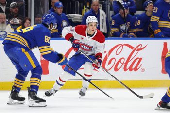 Jan 31, 2026; Buffalo, New York, USA;  Montréal Canadiens right wing Ivan Demidov (93) looks to make a pass as Buffalo Sabres right wing Alex Tuch (89) defends during the third period at KeyBank Center. Mandatory Credit: Timothy T. Ludwig-Imagn Images