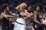 Feb 11, 2026; Philadelphia, Pennsylvania, USA; New York Knicks center Karl-Anthony Towns (32) drives against Philadelphia 76ers guard Kelly Oubre Jr. (9) and forward Marjon Beauchamp (16) during the first half at Xfinity Mobile Arena. Mandatory Credit: Bill Streicher-Imagn Images
