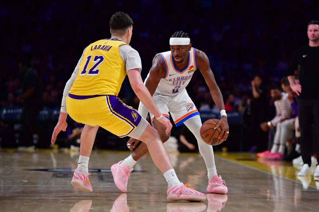 April 7, 2026; Los Angeles, California, USA; Oklahoma City Thunder guard Shai Gilgeous-Alexander (2) moves the ball against Los Angeles Lakers forward Jake LaRavia (12) during the second half at Crypto.com Arena. Mandatory Credit: Gary A. Vasquez-Imagn Images