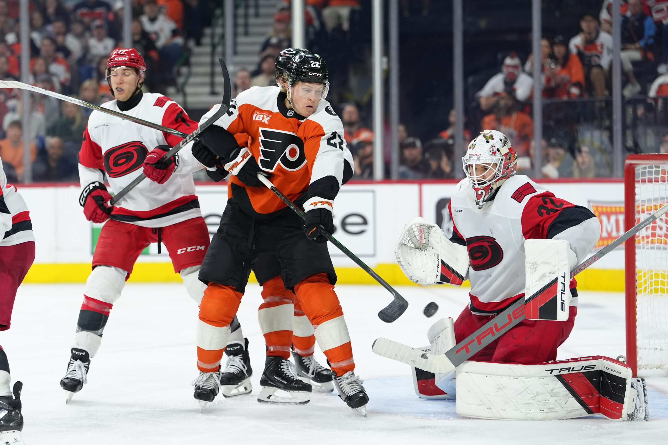 Apr 13, 2026; Philadelphia, Pennsylvania, USA; Philadelphia Flyers center Christian Dvorak (22) attempts to deflect a shot against Carolina Hurricanes goalie Brandon Bussi (32) in the third period at Xfinity Mobile Arena. Mandatory Credit: Kyle Ross-Imagn Images