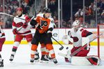 Apr 13, 2026; Philadelphia, Pennsylvania, USA; Philadelphia Flyers center Christian Dvorak (22) attempts to deflect a shot against Carolina Hurricanes goalie Brandon Bussi (32) in the third period at Xfinity Mobile Arena. Mandatory Credit: Kyle Ross-Imagn Images