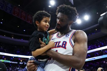 Apr 30, 2026; Philadelphia, Pennsylvania, USA; Philadelphia 76ers center Joel Embiid (21) carries his son Arthur on the court after a victory against the Boston Celtics at Xfinity Mobile Arena. Mandatory Credit: Bill Streicher-Imagn Images