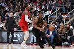 May 1, 2026; Toronto, Ontario, CAN; Cleveland Cavaliers guard Donovan Mitchell (45) controls the ball as Toronto Raptors forward RJ Barrett (9) tries to defend during the overtime period in game six of the first round of the 2026 NBA Playoffs at Scotiabank Arena. Mandatory Credit: Nick Turchiaro-Imagn Images