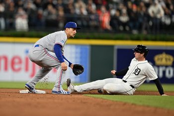 May 2, 2026; Detroit, Michigan, USA;  Detroit Tigers third baseman Colt Keith (33) steals second base ahead of the throw to Texas Rangers shortstop Corey Seager (5) in the fifth inning at Comerica Park. Mandatory Credit: Lon Horwedel-Imagn Images