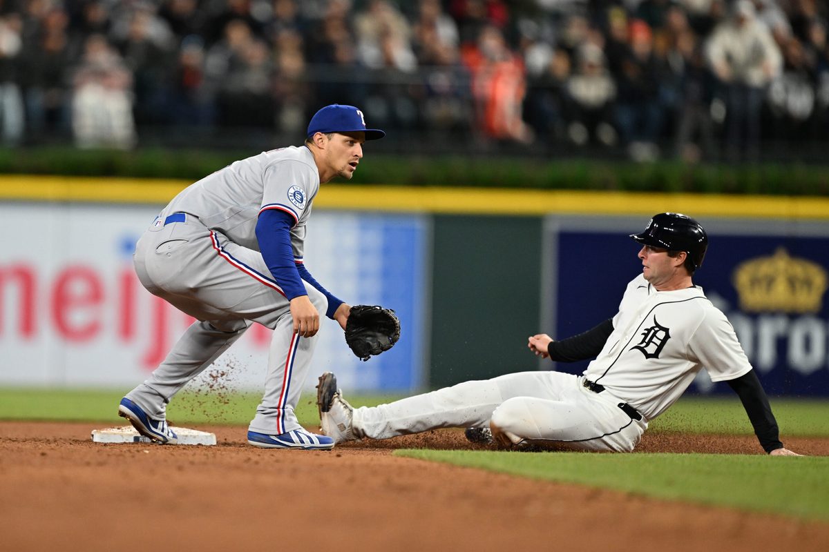 May 2, 2026; Detroit, Michigan, USA; Detroit Tigers third baseman Colt Keith (33) steals second base ahead of the throw to Texas Rangers shortstop Corey Seager (5) in the fifth inning at Comerica Park. Mandatory Credit: Lon Horwedel-Imagn Images