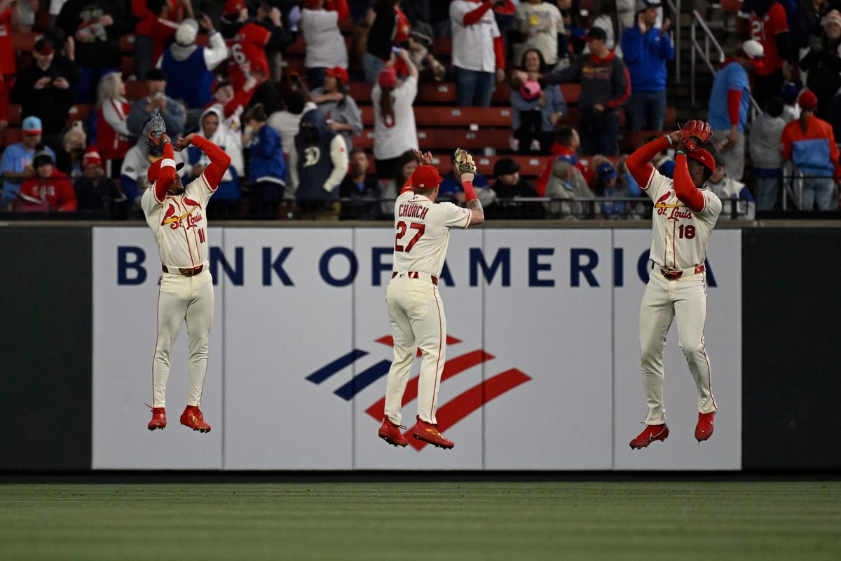 May 2, 2026; St. Louis, Missouri, USA; St. Louis Cardinals center fielder Victor Scott II (11), St. Louis Cardinals left fielder Nathan Church (27) and St. Louis Cardinals right fielder Jordan Walker (18) celebrate after beating the Los Angeles Dodgers at Busch Stadium. Mandatory Credit: Joe Puetz-Imagn Images