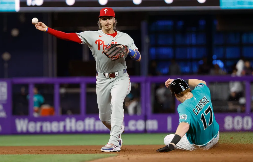 May 3, 2026; Miami, Florida, USA; Miami Marlins right fielder Owen Caissie (17) is out at second base as Philadelphia Phillies second baseman Bryson Stott (5) throws to first for the double play during the eighth inning at loanDepot Park. Mandatory Credit: Rhona Wise-Imagn Images