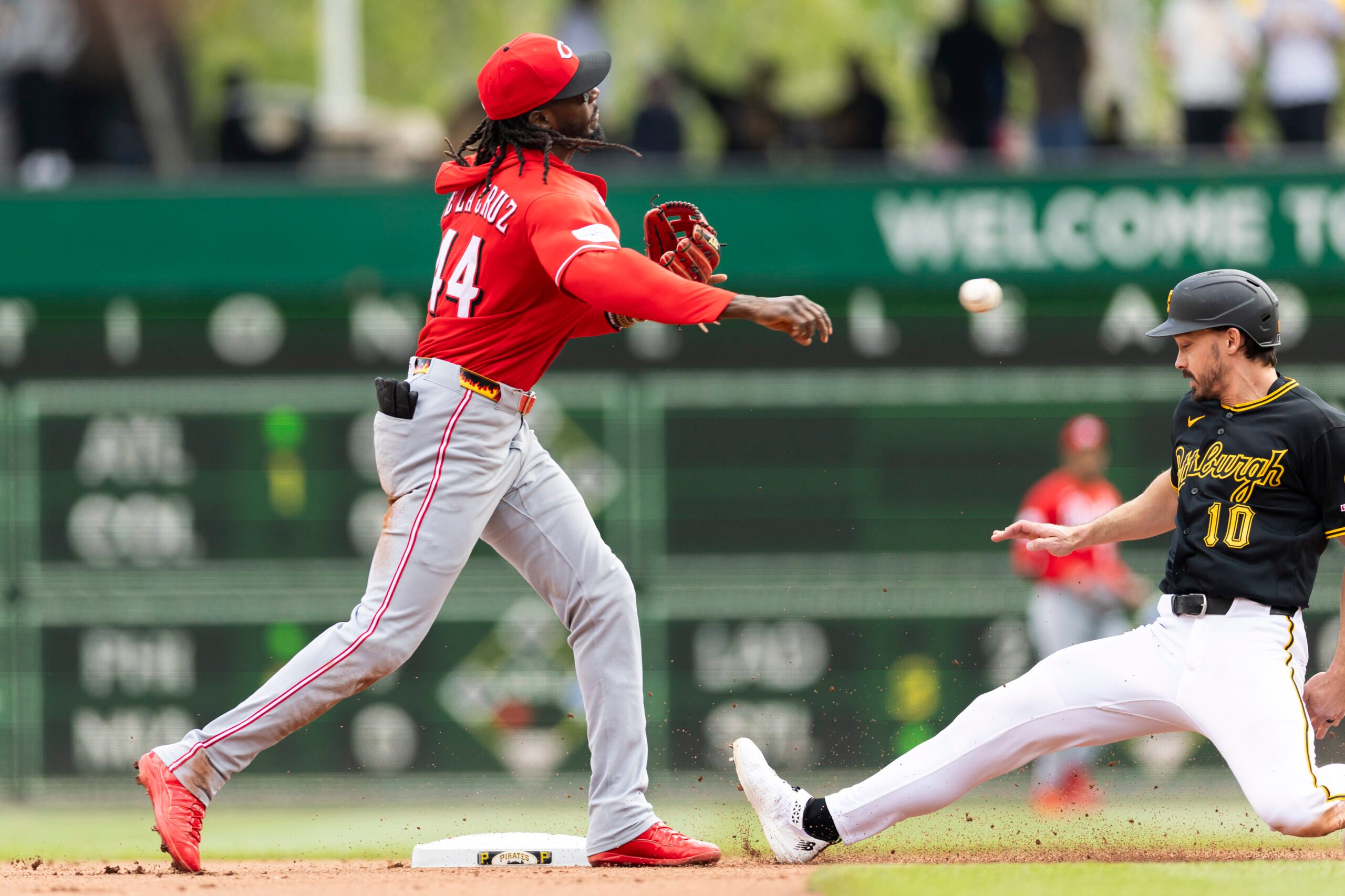 May 3, 2026; Pittsburgh, Pennsylvania, USA;  Cincinnati Reds shortstop Elly De La Cruz (44) makes the throw to complete a double play as Pittsburgh Pirates left fielder Bryan Reynolds (10) slides into second base during the seventh inning at PNC Park. Mandatory Credit: Scott Galvin-Imagn Images