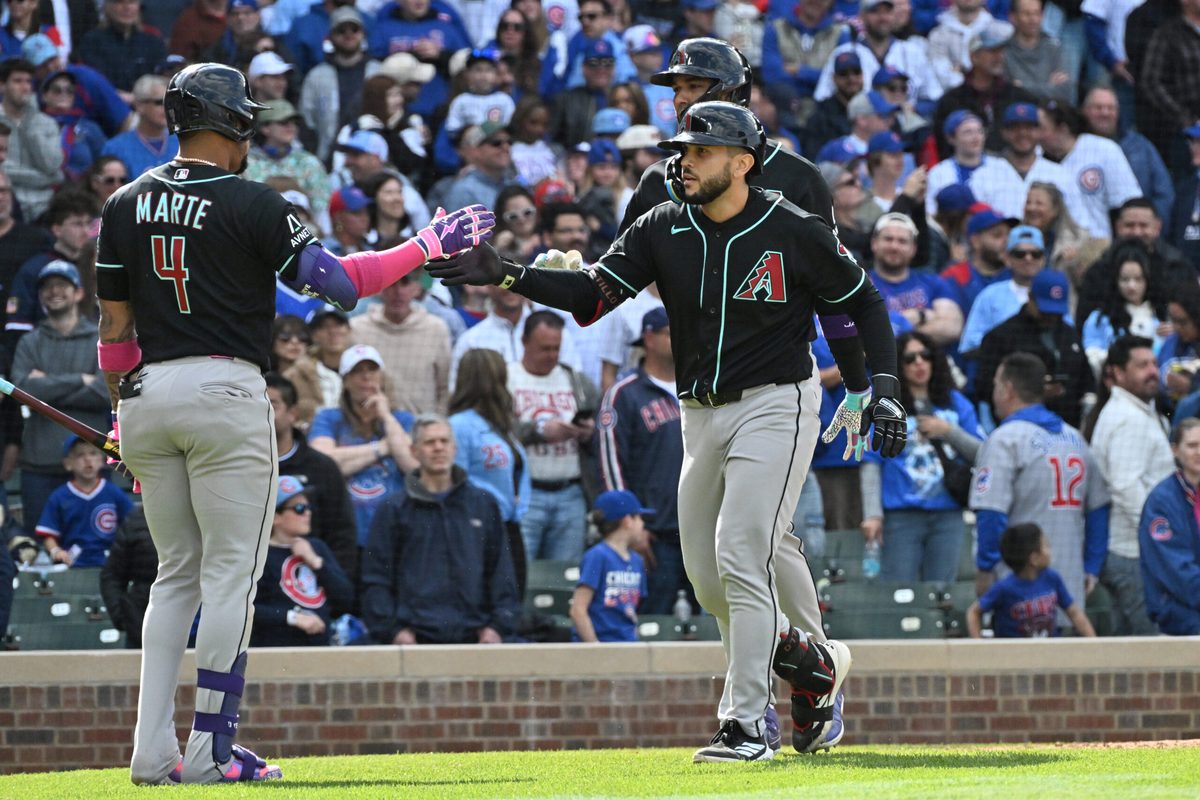 May 3, 2026; Chicago, Illinois, USA; Arizona Diamondbacks catcher Adrian Del Castillo (25) celebrates his two-run home run with second baseman Ketel Marte (4) and left fielder Lourdes Gurriel Jr. (12) against the Chicago Cubs during the ninth inning at Wrigley Field. Mandatory Credit: Patrick Gorski-Imagn Images