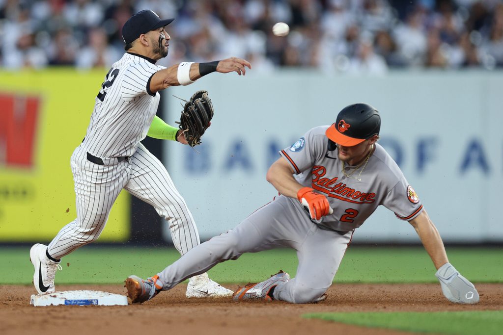 May 4, 2026; Bronx, New York, USA; New York Yankees shortstop Jose Caballero (72) forces out Baltimore Orioles shortstop Gunnar Henderson (2) at second base and throws to first to complete the double play on a ball hit by
catcher Adley Rutschman (not pictured) during the third inning at Yankee Stadium. Mandatory Credit: Vincent Carchietta-Imagn Images