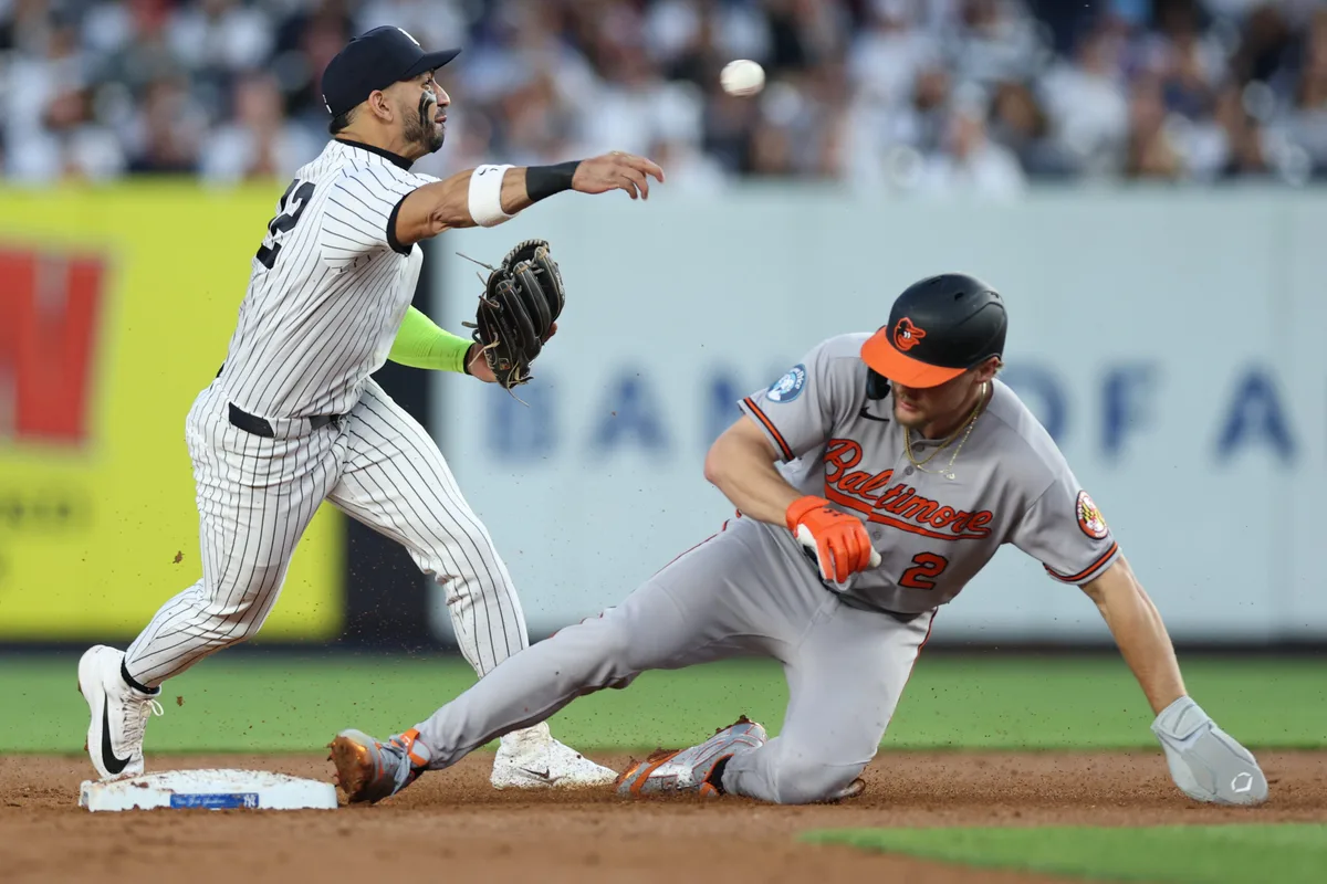 May 4, 2026; Bronx, New York, USA; New York Yankees shortstop Jose Caballero (72) forces out Baltimore Orioles shortstop Gunnar Henderson (2) at second base and throws to first to complete the double play on a ball hit by
catcher Adley Rutschman (not pictured) during the third inning at Yankee Stadium. Mandatory Credit: Vincent Carchietta-Imagn Images