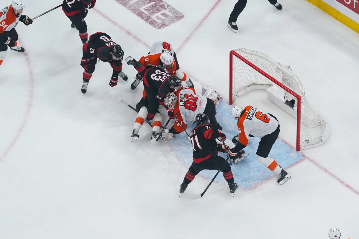 May 4, 2026; Raleigh, North Carolina, USA; Carolina Hurricanes left wing Taylor Hall (71) scores the game winning goal past Philadelphia Flyers goaltender Dan Vladar (80) and defenseman Travis Sanheim (6) during the first overtime in game two of the second round of the 2026 Stanley Cup Playoffs at Lenovo Center. Mandatory Credit: James Guillory-Imagn Images