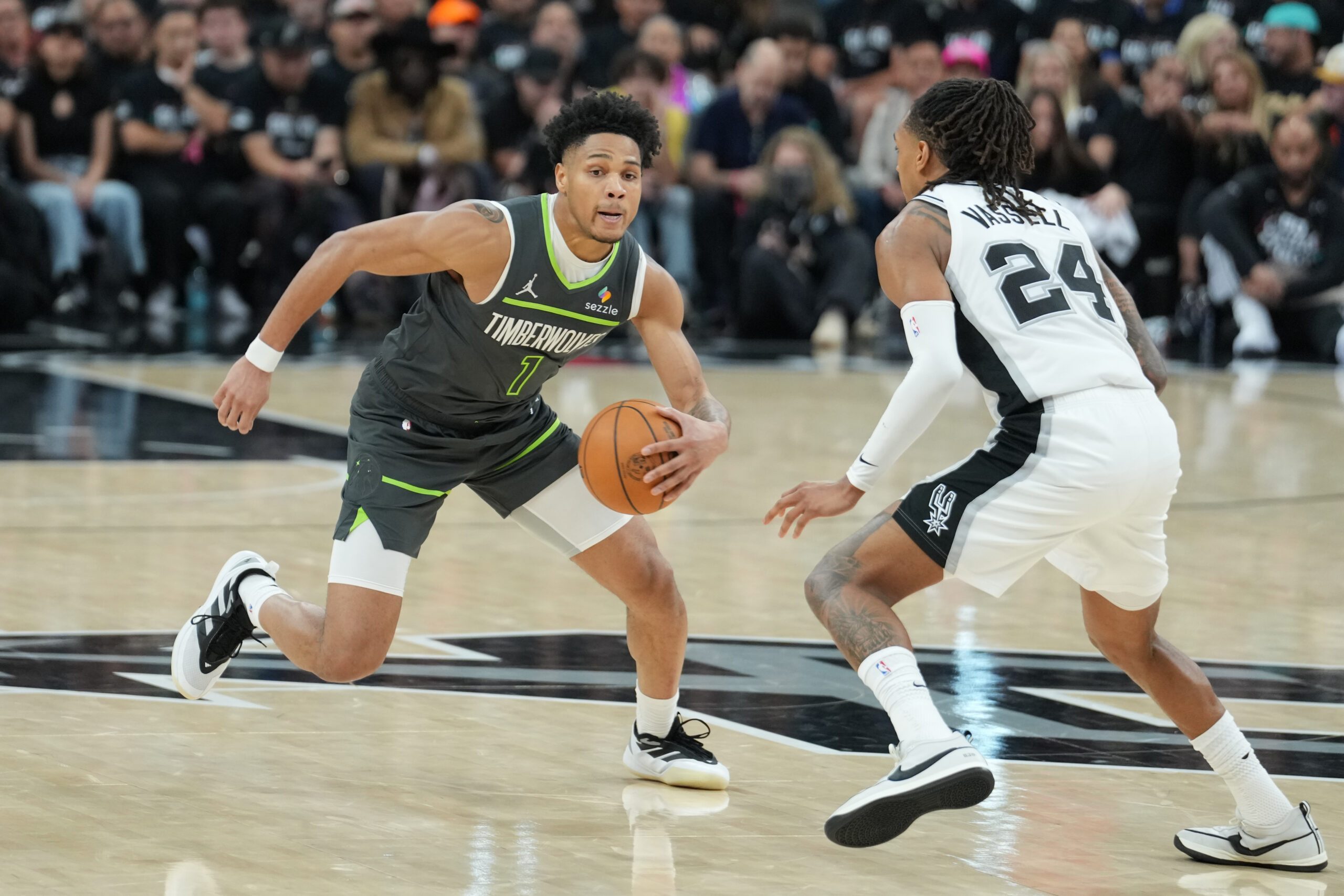 May 6, 2026; San Antonio, Texas, USA; Minnesota Timberwolves guard Terrence Shannon Jr. (1) dribbles against San Antonio Spurs guard Devin Vassell (24) in the second half during game two of the second round of the 2026 NBA Playoffs at Frost Bank Center. Mandatory Credit: Daniel Dunn-Imagn Images