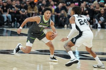 May 6, 2026; San Antonio, Texas, USA; Minnesota Timberwolves guard Terrence Shannon Jr. (1) dribbles against San Antonio Spurs guard Devin Vassell (24) in the second half during game two of the second round of the 2026 NBA Playoffs at Frost Bank Center. Mandatory Credit: Daniel Dunn-Imagn Images