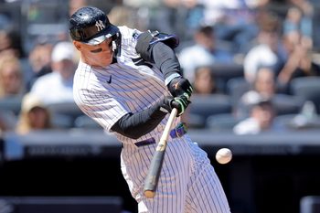 May 7, 2026; Bronx, New York, USA; New York Yankees designated hitter Aaron Judge (99) hits an RBI single against the Texas Rangers during the sixth inning at Yankee Stadium. Mandatory Credit: Brad Penner-Imagn Images
