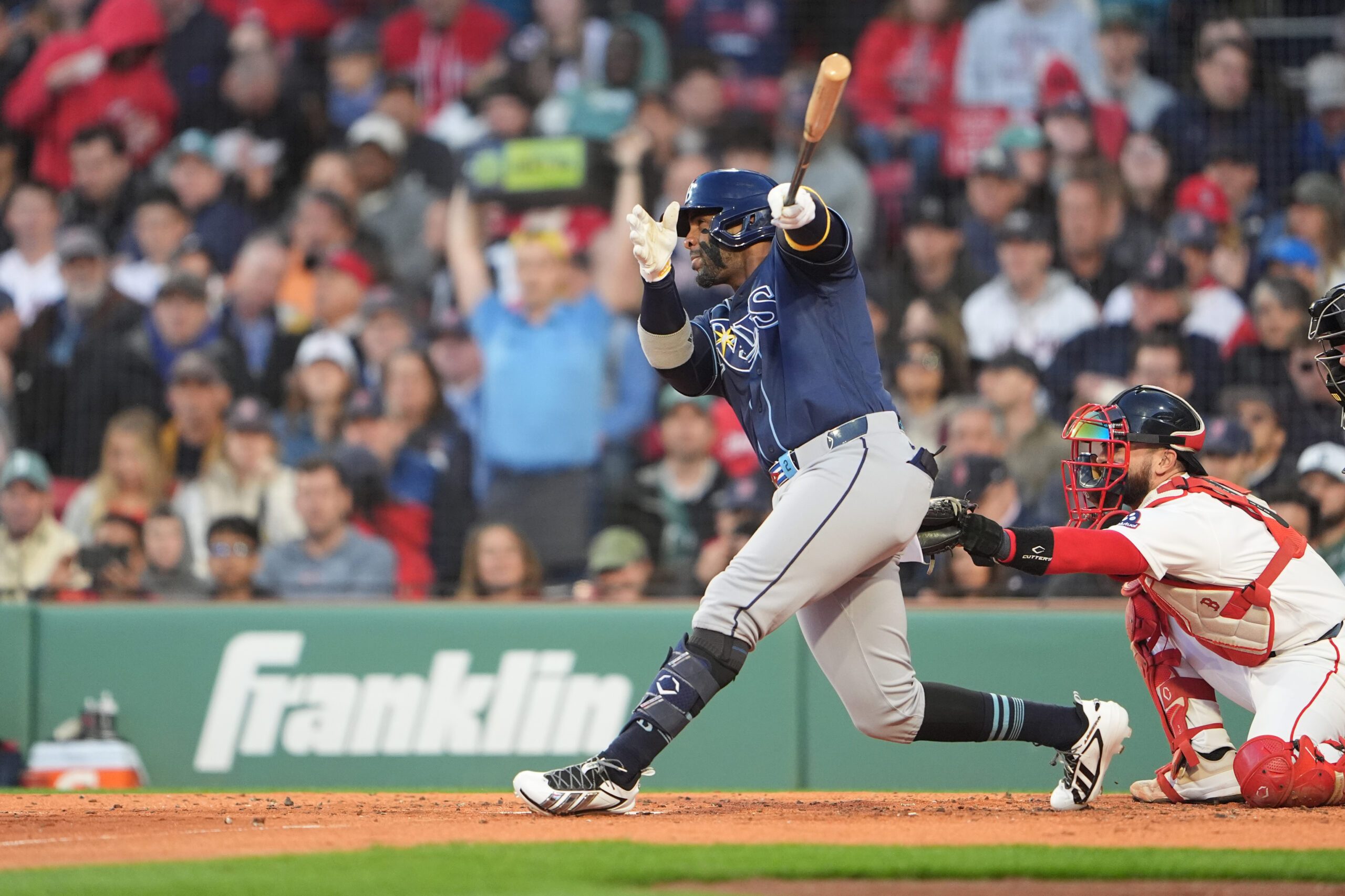 May 7, 2026; Boston, Massachusetts, USA; Tampa Bay Rays designated hitter Yandy Diaz (2) hits a sacrifice fly ball against the Boston Red Sox during the second inning at Fenway Park. Mandatory Credit: Gregory Fisher-Imagn Images