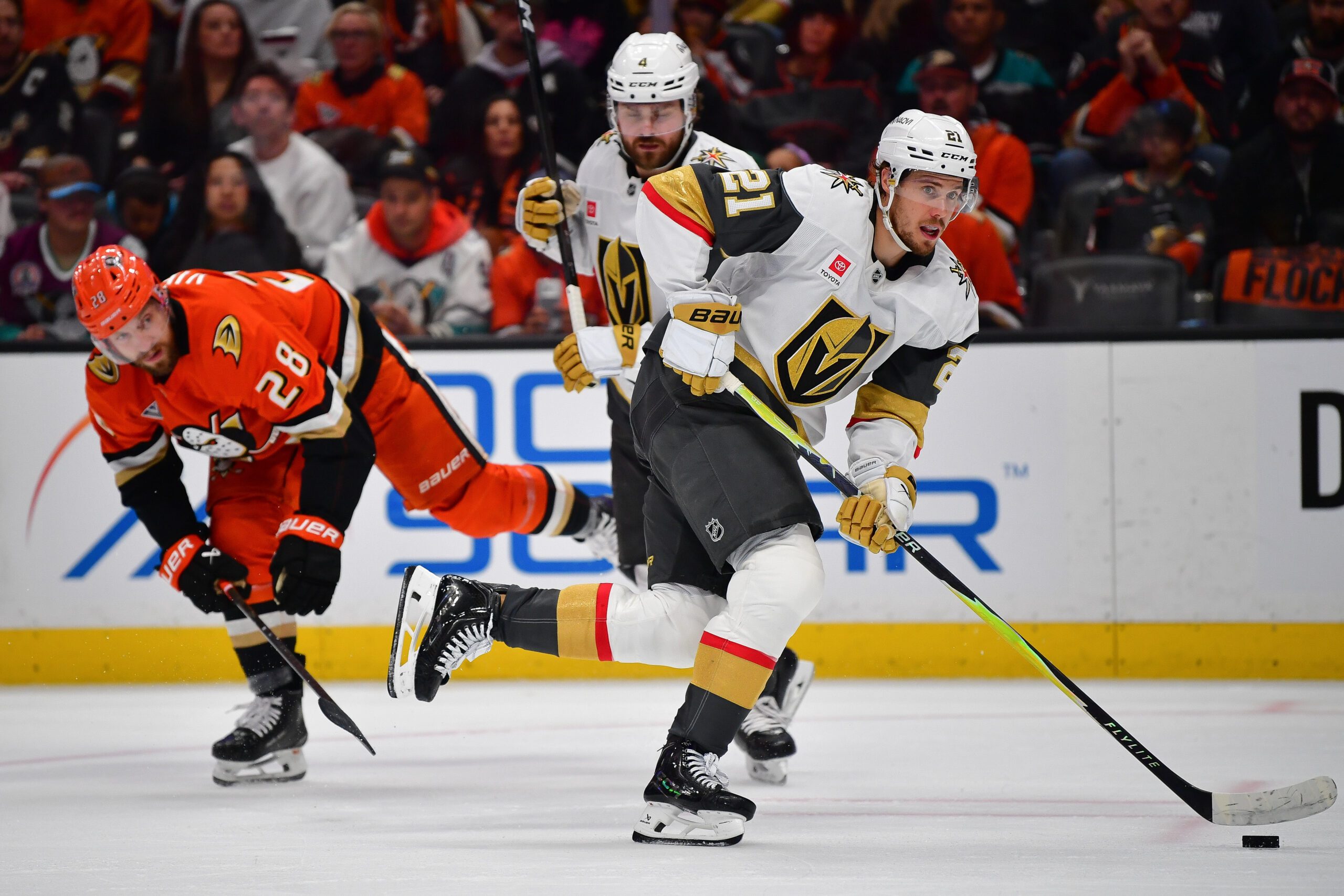 May 8, 2026; Anaheim, California, USA; Vegas Golden Knights center Brett Howden (21) moves the puck ahead of Anaheim Ducks left wing Jeffrey Viel (28) during the second period in game three of the second round of the 2026 Stanley Cup Playoffs at Honda Center. Mandatory Credit: Gary A. Vasquez-Imagn Images