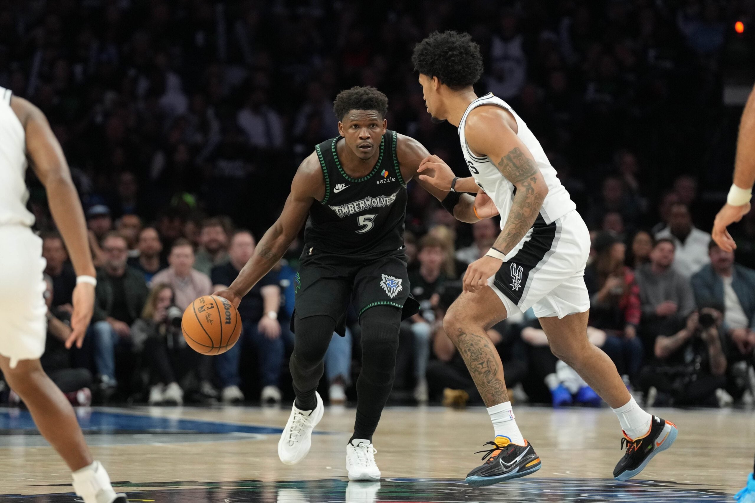 May 8, 2026; Minneapolis, Minnesota, USA; Minnesota Timberwolves guard Anthony Edwards (5) dribbles against the San Antonio Spurs guard Dylan Harper (2) in the second half during game three of the second round of the 2026 NBA Playoffs at Target Center. Mandatory Credit: Jesse Johnson-Imagn Images