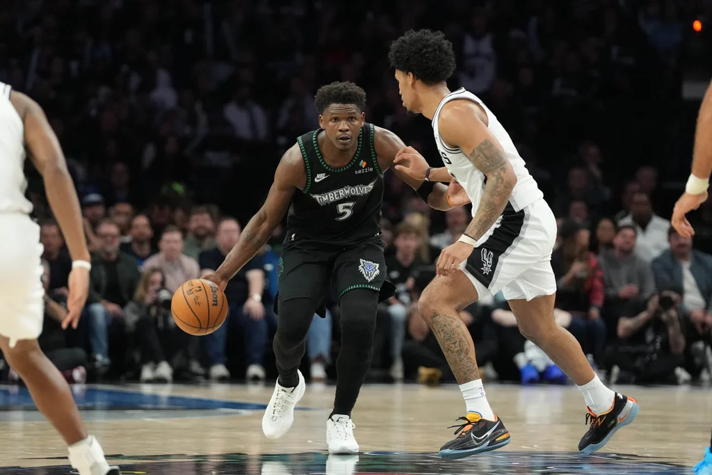 May 8, 2026; Minneapolis, Minnesota, USA; Minnesota Timberwolves guard Anthony Edwards (5) dribbles against the San Antonio Spurs guard Dylan Harper (2) in the second half during game three of the second round of the 2026 NBA Playoffs at Target Center. Mandatory Credit: Jesse Johnson-Imagn Images