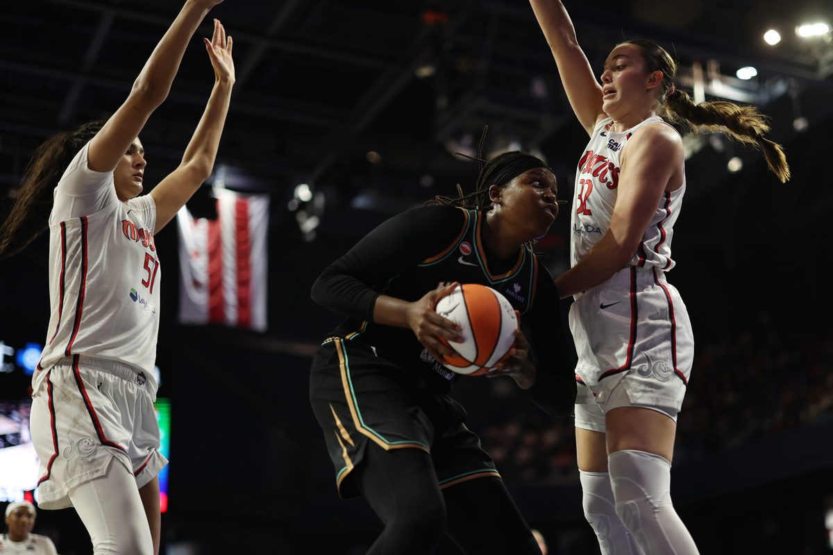 May 10, 2026; Washington, District of Columbia, USA; New York Liberty center Jonquel Jones (35) drives to the basket as Washington Mystics center Lauren Betts (51) and Mystics forward Angela Dugalic (32) defend in the second half at CareFirst Arena. Mandatory Credit: Geoff Burke-Imagn Images