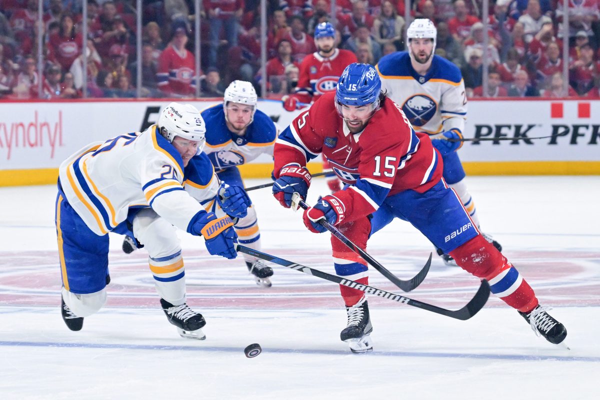 May 10, 2026; Montreal, Quebec, CAN; Montreal Canadiens forward Alex Newhook (15) on his way to score an empty net goal and Buffalo Sabres defenseman Rasmus Dahlin (26) defending during the third period in game three of the second round of the 2026 Stanley Cup Playoffs at the Bell Centre. Mandatory Credit: Eric Bolte-Imagn Images