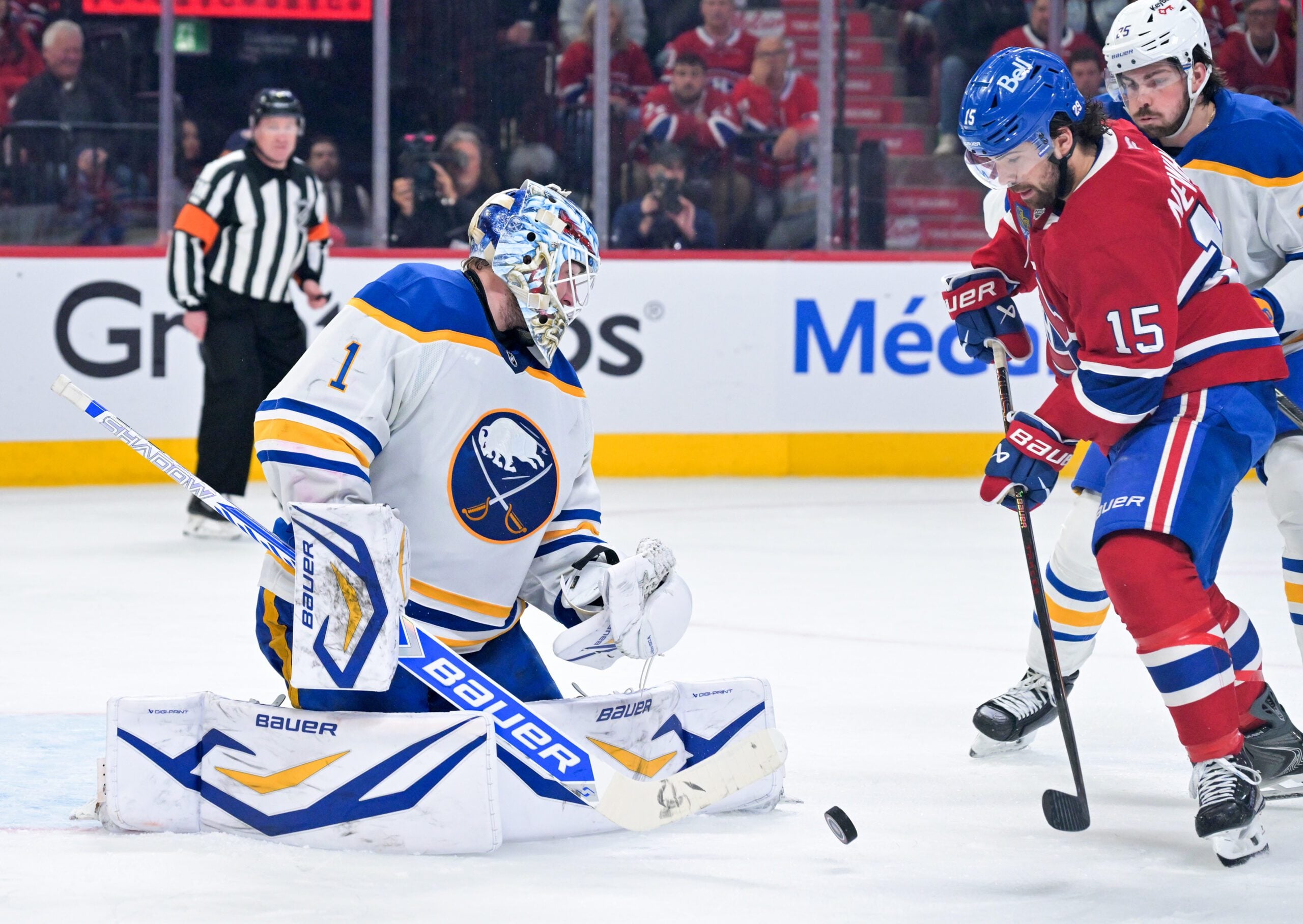 May 12, 2026; Montreal, Quebec, CAN; Buffalo Sabres goalie Ukko-Pekka Luukkonen (1) stops Montreal Canadiens forward Alex Newhook (15) during the third period in game four of the second round of the 2026 Stanley Cup Playoffs at Bell Centre. Mandatory Credit: Eric Bolte-Imagn Images