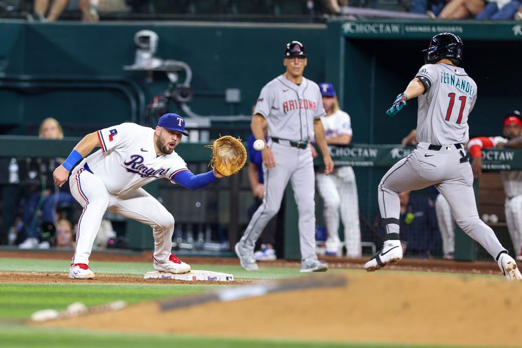 May 12, 2026; Arlington, Texas, USA; Texas Rangers first baseman Jake Burger (21) covers first base on a ground ball by Arizona Diamondbacks first baseman Jose Fernandez (11) during the eighth inning at Globe Life Field. Mandatory Credit: Andrew Dieb-Imagn Images