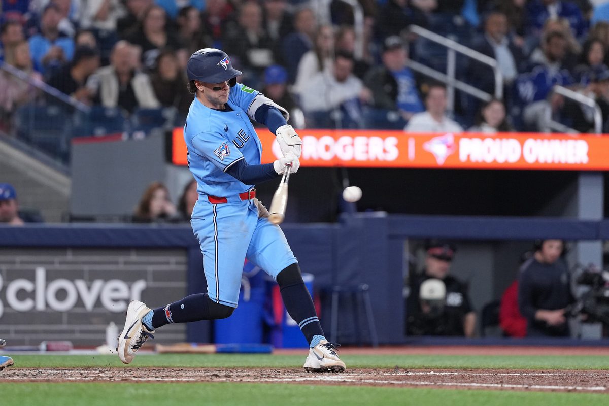 May 12, 2026; Toronto, Ontario, CAN; Toronto Blue Jays shortstop Ernie Clement (22) hits a single against the Tampa Bay Rays during the seventh inning at Rogers Centre. Mandatory Credit: Nick Turchiaro-Imagn Images