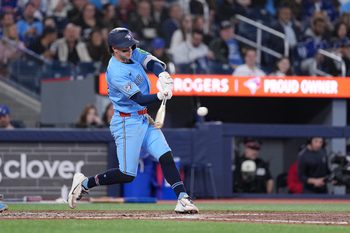 May 12, 2026; Toronto, Ontario, CAN; Toronto Blue Jays shortstop Ernie Clement (22) hits a single against the Tampa Bay Rays during the seventh inning at Rogers Centre. Mandatory Credit: Nick Turchiaro-Imagn Images