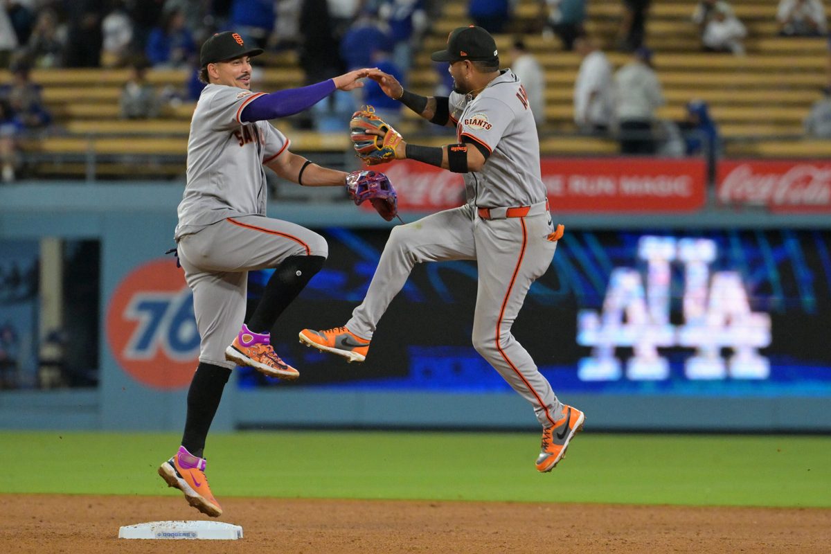 May 12, 2026; Los Angeles, California, USA; San Francisco Giants shortstop Willy Adames (2) and second baseman Luis Arraez (1) celebrate after defeating the Los Angeles Dodgers in the ninth inning at Dodger Stadium. Mandatory Credit: Jayne Kamin-Oncea-Imagn Images