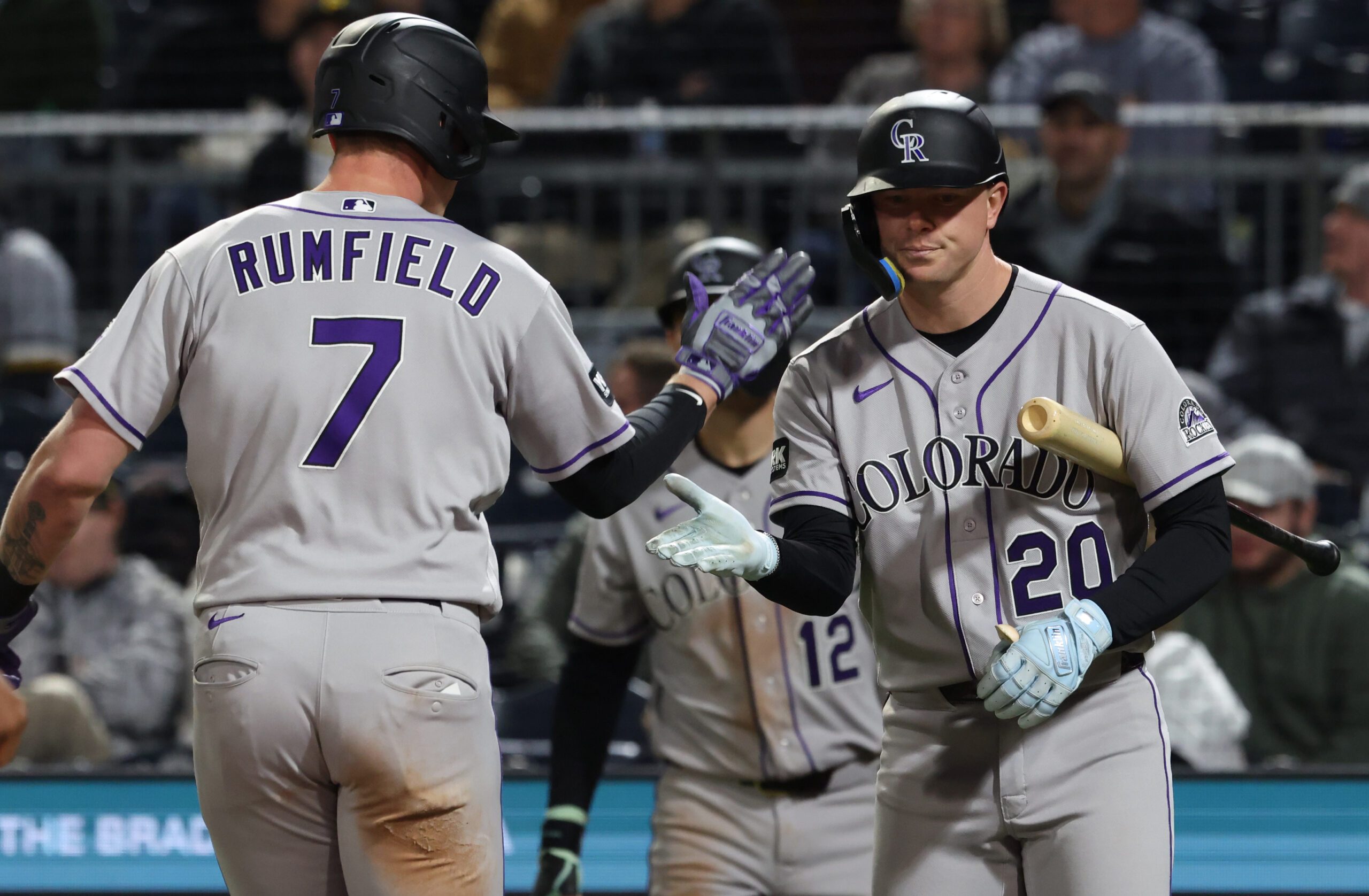 May 13, 2026; Pittsburgh, Pennsylvania, USA;  Colorado Rockies first baseman TJ Rumfield (7) celebrates his solo home run with designated hitter Troy Johnston (20) against the Pittsburgh Pirates during the eighth inning at PNC Park. Mandatory Credit: Charles LeClaire-Imagn Images
