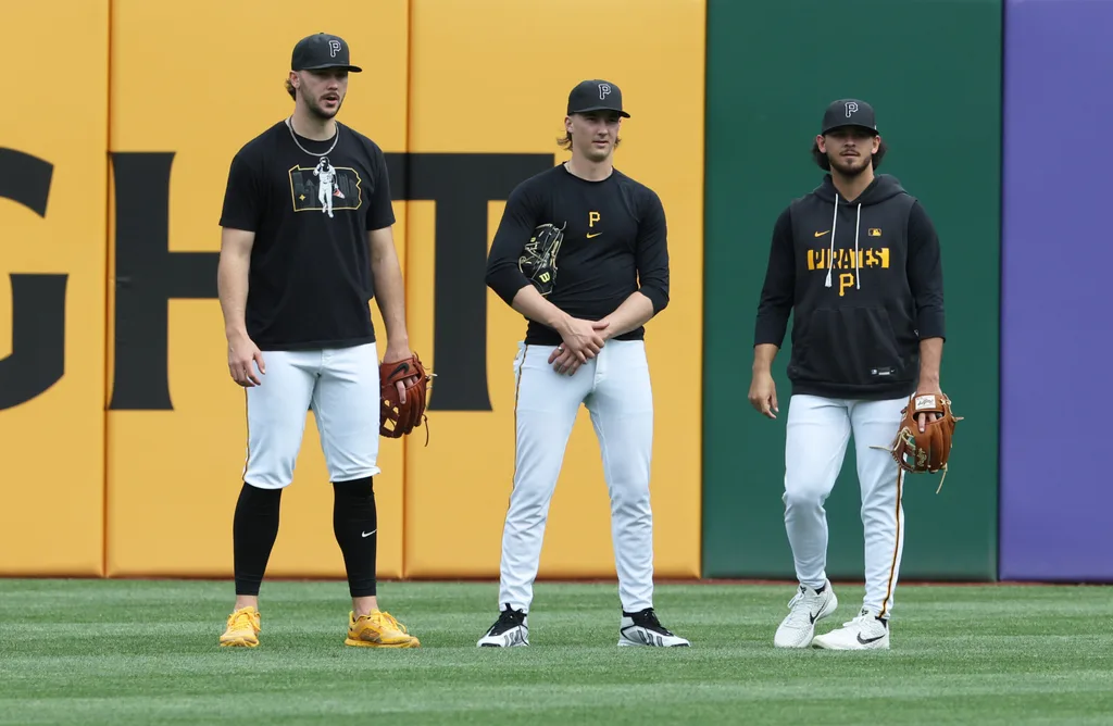 May 15, 2026; Pittsburgh, Pennsylvania, USA; Pittsburgh Pirates starting pitchers Paul Skenes (left) and Bubba Chandler (middle) and Jared Jones (right) talk in the outfield before the game against the Philadelphia Phillies at PNC Park. Mandatory Credit: Charles LeClaire-Imagn Images