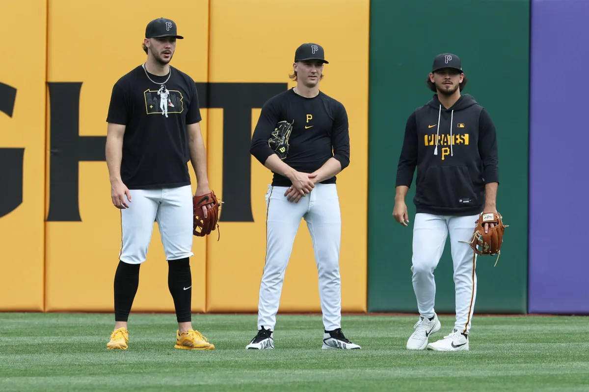 May 15, 2026; Pittsburgh, Pennsylvania, USA; Pittsburgh Pirates starting pitchers Paul Skenes (left) and Bubba Chandler (middle) and Jared Jones (right) talk in the outfield before the game against the Philadelphia Phillies at PNC Park. Mandatory Credit: Charles LeClaire-Imagn Images