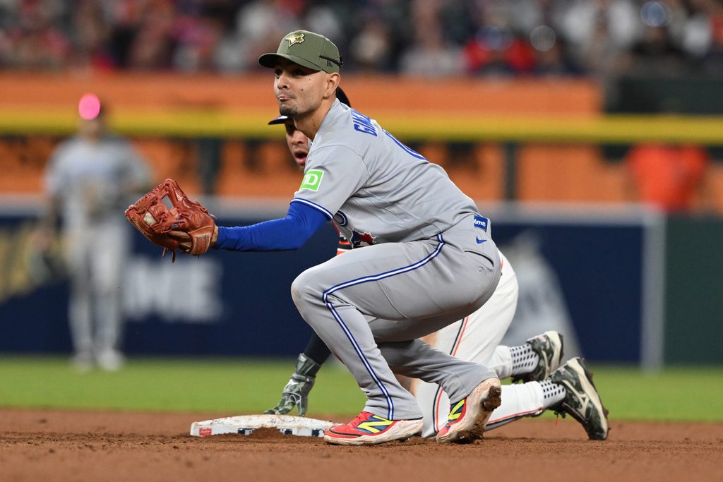 May 15, 2026; Detroit, Michigan, USA; Toronto Blue Jays shortstop Andrés Giménez (0) tags out Detroit Tigers pinch Jahmai Jones (18) on a steal attempt in the eighth inning at Comerica Park. Mandatory Credit: Lon Horwedel-Imagn Images