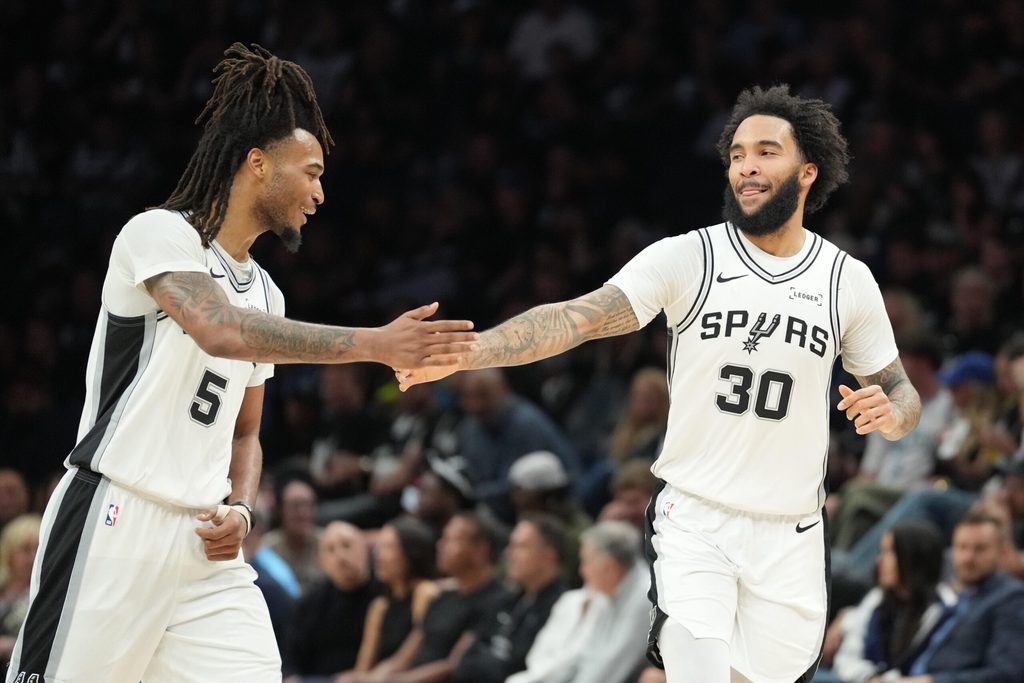 May 15, 2026; Minneapolis, Minnesota, USA; San Antonio Spurs forward Julian Champagnie (30) celebrates with guard Stephon Castle (5) in the second half against the Minnesota Timberwolves during game six of the second round of the 2026 NBA Playoffs at Target Center. Mandatory Credit: Jesse Johnson-Imagn Images