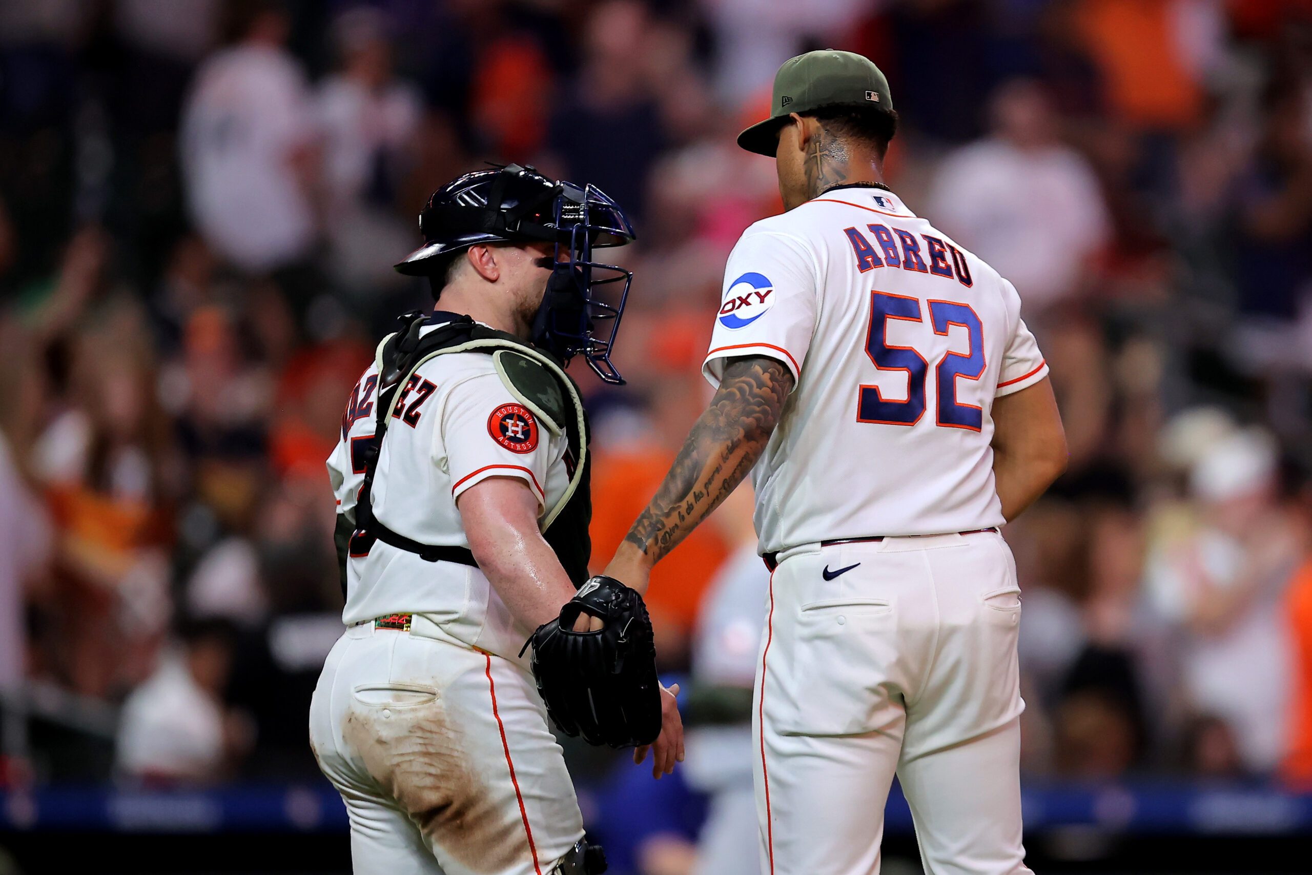 May 16, 2026; Houston, Texas, USA; Houston Astros pitcher Bryan Abreu (52) and catcher Christian Vasquez (2) congratulate each other after the final out against the Texas Rangers during the ninth inning at Daikin Park. Mandatory Credit: Erik Williams-Imagn Images
