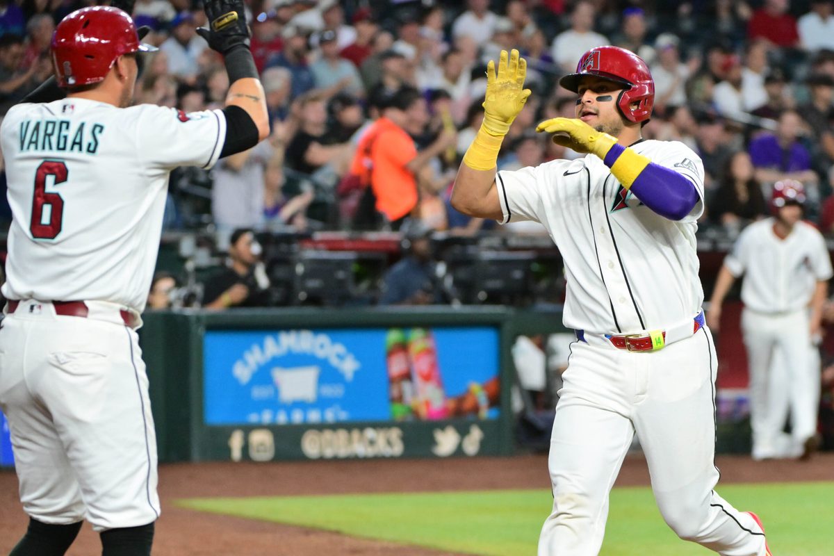 May 18, 2026; Phoenix, Arizona, USA; Arizona Diamondbacks catcher Gabriel Moreno (14) scores and celebrates with first baseman Ildemaro Vargas (6) in the third inning against the San Francisco Giants at Chase Field. Mandatory Credit: Matt Kartozian-Imagn Images