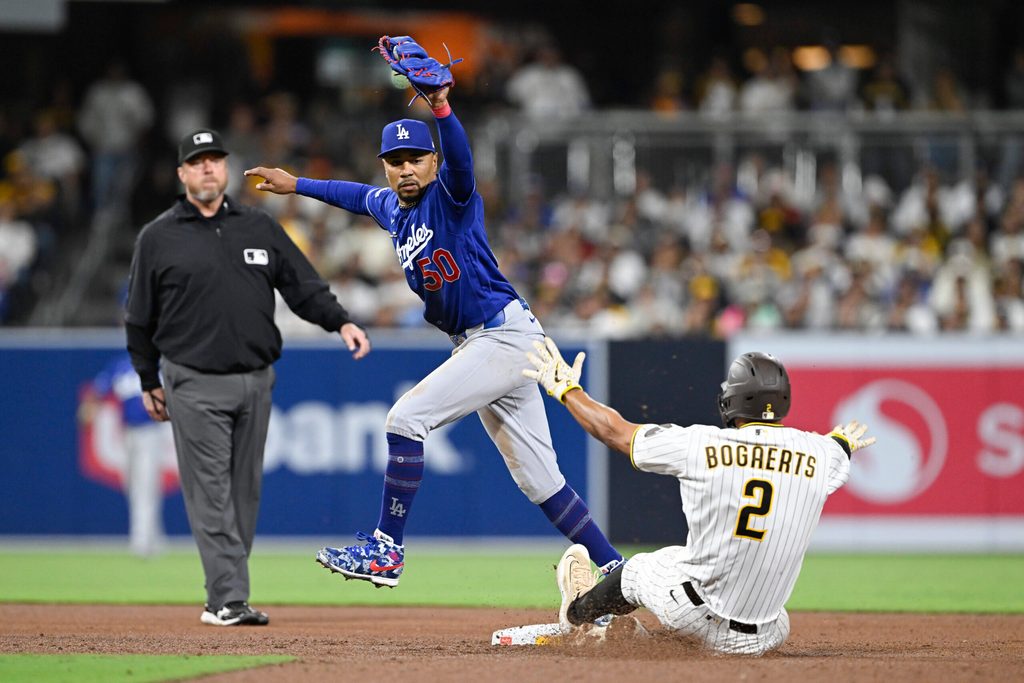 May 18, 2026; San Diego, California, USA; Los Angeles Dodgers shortstop Mookie Betts (50) gets the force out on San Diego Padres shortstop Xander Bogaerts (2) during the seventh inning at Petco Park. Mandatory Credit: Denis Poroy-Imagn Images