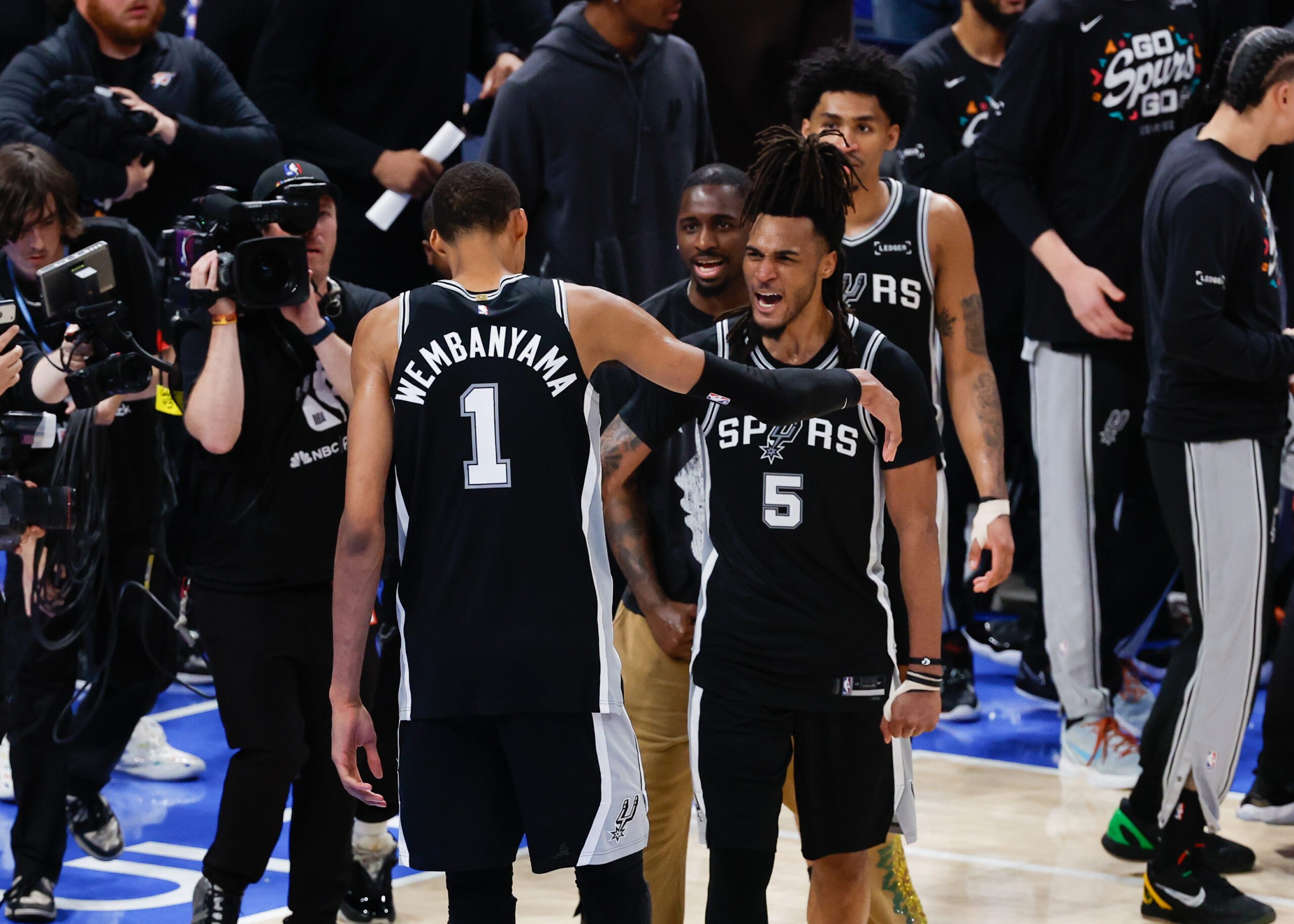May 18, 2026; Oklahoma City, Oklahoma, USA; San Antonio Spurs center Victor Wembanyama (1) celebrates with San Antonio Spurs guard Stephon Castle (5) after defeating the Oklahoma City Thunder in double overtime against  during game one of the western conference finals for the 2026 NBA playoffs at Paycom Center. Mandatory Credit: Alonzo Adams-Imagn Images