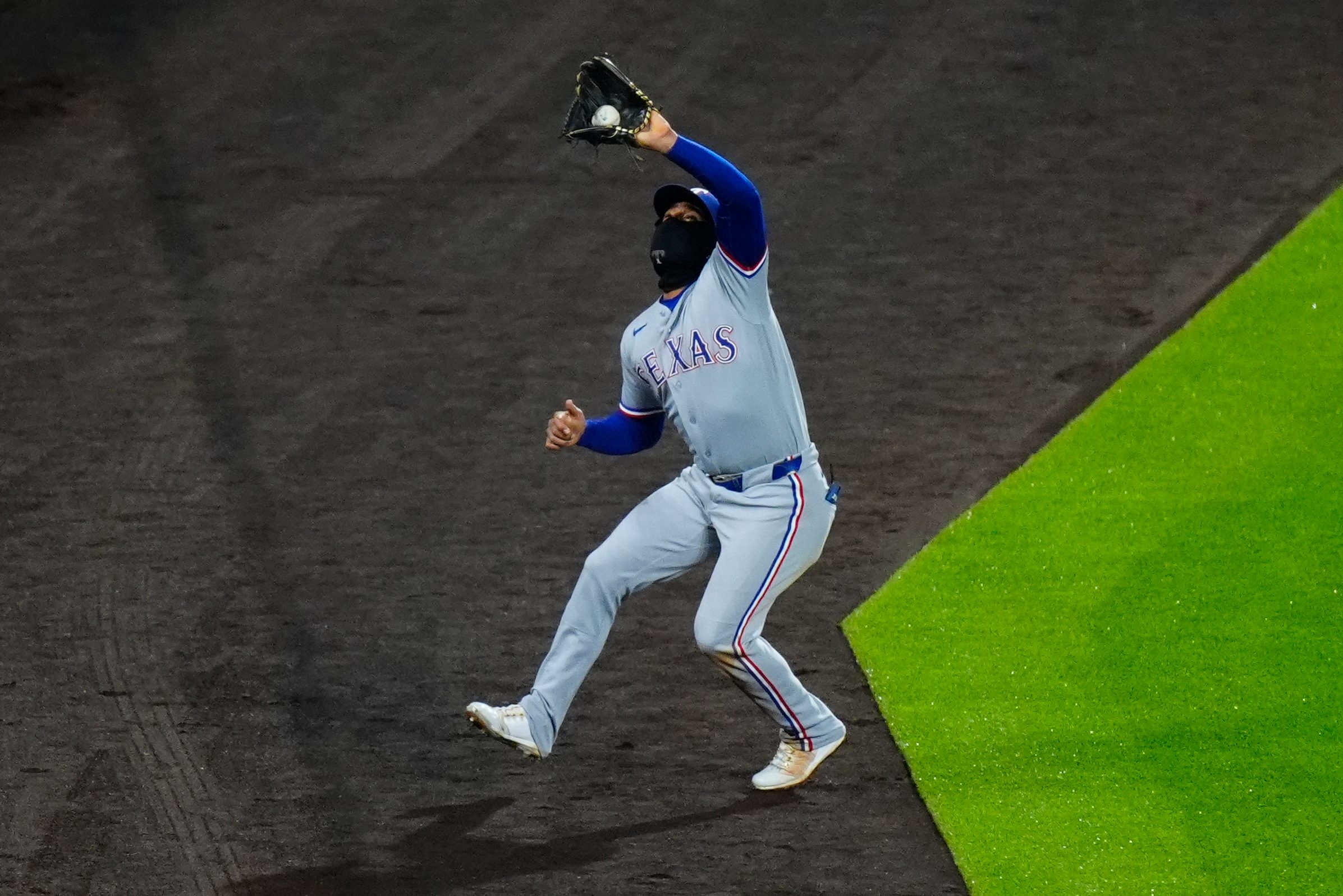 May 19, 2026; Denver, Colorado, USA; Texas Rangers second baseman Ezequiel Duran (20) makes the final out of the ninth inning against the Colorado Rockies at Coors Field. Mandatory Credit: Ron Chenoy-Imagn Images