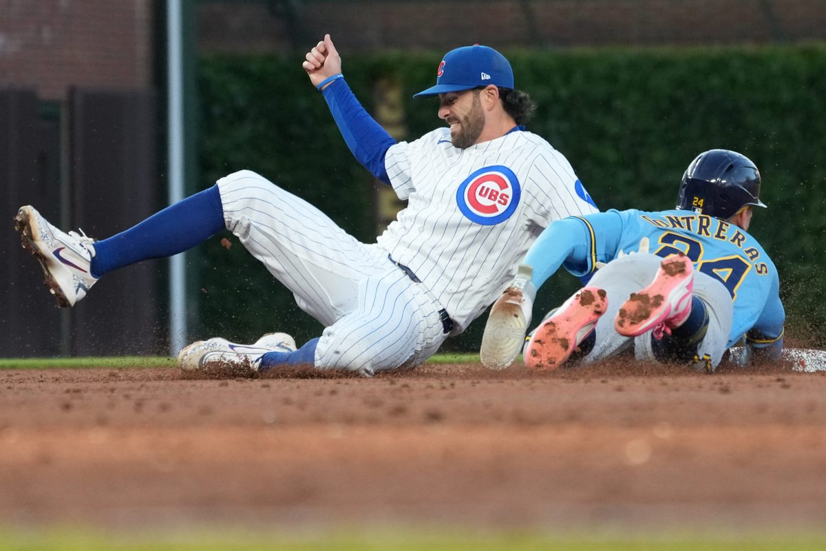 May 20, 2026; Chicago, Illinois, USA; Milwaukee Brewers catcher William Contreras (24) steals second base as Chicago Cubs shortstop Dansby Swanson (7) can’t handle the throw during the third inning at Wrigley Field. Mandatory Credit: David Banks-Imagn Images