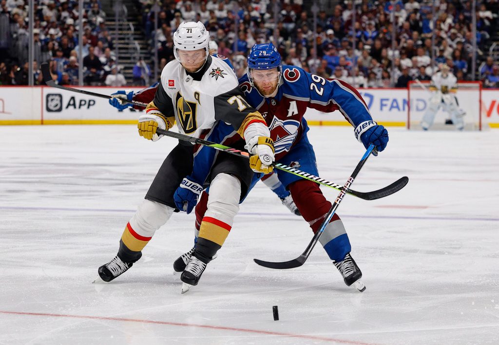 May 20, 2026; Denver, Colorado, USA; Vegas Golden Knights center William Karlsson (71) and Colorado Avalanche center Nathan MacKinnon (29) battle for the puck during the third period in game one of the Western Conference Final of the 2026 Stanley Cup Playoffs at Ball Arena. Mandatory Credit: Isaiah J. Downing-Imagn Images
