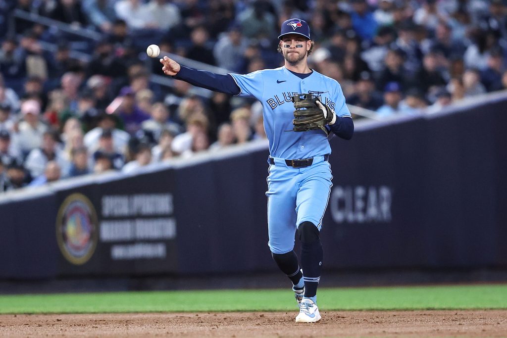 May 21, 2026; Bronx, New York, USA; Toronto Blue Jays shortstop Ernie Clement (22) throws a runner out at first base in the third inning against the New York Yankees at Yankee Stadium. Mandatory Credit: Wendell Cruz-Imagn Images