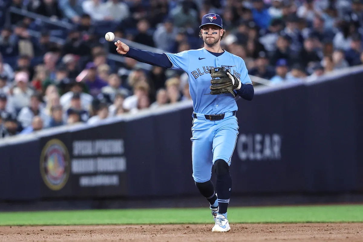 May 21, 2026; Bronx, New York, USA; Toronto Blue Jays shortstop Ernie Clement (22) throws a runner out at first base in the third inning against the New York Yankees at Yankee Stadium. Mandatory Credit: Wendell Cruz-Imagn Images