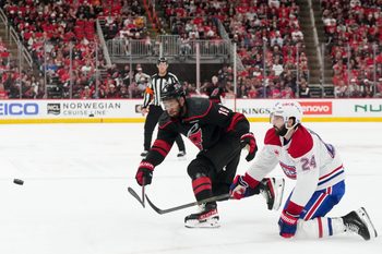 May 21, 2026; Raleigh, North Carolina, USA; Carolina Hurricanes defenseman K'andre Miller (19) passes the puck defended by Montreal Canadiens center Phillip Danault (24) during the third period in game one of the Eastern Conferene Final of the 2026 Stanley Cup Playoffs at Lenovo Center. Mandatory Credit: James Guillory-Imagn Images