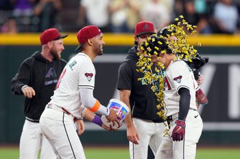 May 21, 2026; Phoenix, Arizona, USA; Arizona Diamondbacks right fielder Corbin Carroll (7) is doused with gum by Arizona Diamondbacks left fielder Lourdes Gurriel Jr. (12) after hitting a walk off single against the Colorado Rockies during the ninth inning at Chase Field. Mandatory Credit: Joe Camporeale-Imagn Images